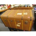 A vintage wooden and iron bound steamer trunk