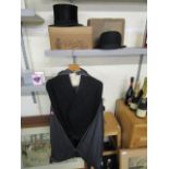 A morning suit, a silk top hat and a bowler hat