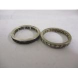 Two white metal eternity rings to include a sapphire ring and a diamond ring