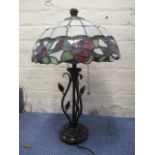 A modern Tiffany style lamp with a floral shade on a bronzed coloured base with leaves, 22" h