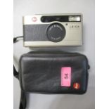 A Leica Minilux camera with case