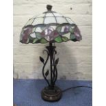 A modern Tiffany style lamp with a floral shade on a bronze coloured base, with leaves, 22" h