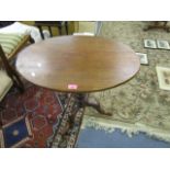 A Georgian mahogany tilt top occasional table, oval top on pedestal base