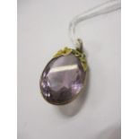 A large amethyst coloured stone set in a yellow mount