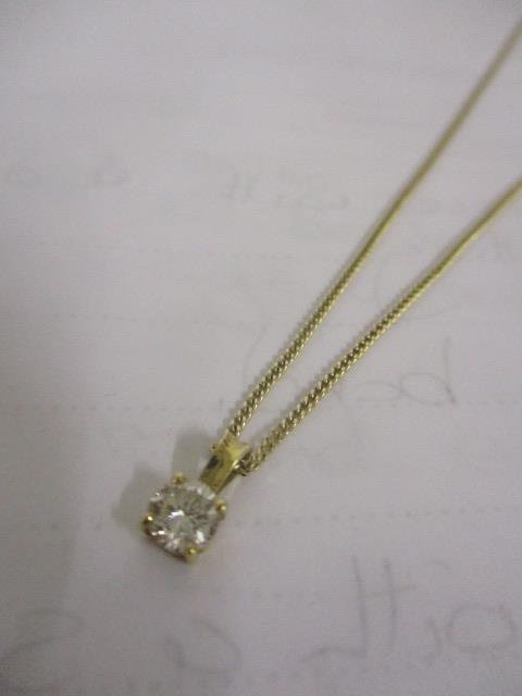 A 9ct gold necklace with diamond pendant in a claw setting