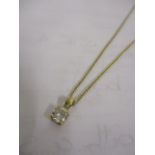 A 9ct gold necklace with diamond pendant in a claw setting