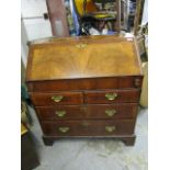 A Georgian walnut bureau, the fall flap revealing a fitted interior of pigeonholes and drawers a