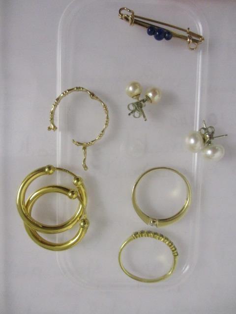 A pair of gold coloured metal earrings stamped 375, an 18ct gold and diamond ring, a yellow metal