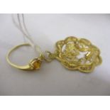 A 14ct gold ring and a gold coloured pendant