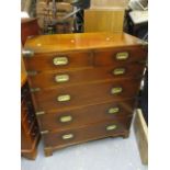 A reproduction military style chest of two and four long graduated drawers, on bracket feet, 40" h x