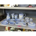 A collection of Wedgewood blue Jasperware to include a mug, trinket boxes and other items