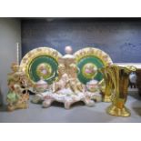 An 20th century continental porcelain desk stand with a candlestick and a pair of inkwells,