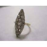 A lozenge shaped diamond cluster ring set in a yellow and white metal mount