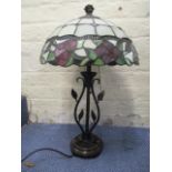 A modern Tiffany style lamp with a floral shade on a bronze coloured base with leaves, 22" h