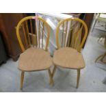 A pair of Ercol stick back chairs