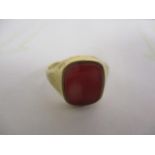 A 9ct gold signet ring set with a red tablet
