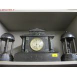 A Victorian black slate and marble mantle clock and two garnitures