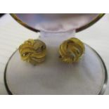 A pair of yellow gold coloured metal earrings