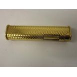 A Dunhill gold plated Butain dress lighter with rounded sides and ribbed body