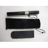 A plated and black enamelled cigar holder inscribed Laque De Chine, a black cloth case and a Mont