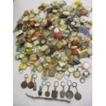 A quantity of mid to late 20th century key rings from around the world to include Shell oil, Peugeot