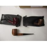 Three, as new and unused James Upshall smoking pipes, two in soft leather cases