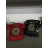 A black Bakelite telephone with a drawer and a vintage red cased telephone