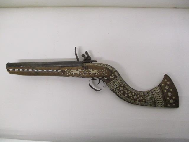 A 20th century bone inlaid Turkish Flintlock action pistol decorated with animals and floral motifs,