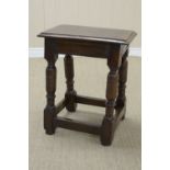 A 17th Century oak Joint Stool on heavy bulbous turned and square legs united by square