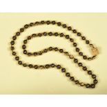 A Charles de Temple Hematite and 18ct gold Necklace comprised of seventy beads each encapsulated