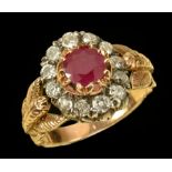 A Ruby and Diamond Cluster Ring claw-set round ruby within a frame of twelve old-cut diamonds