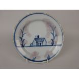 An early 18th Century Plate painted naive House with stylised trees having sponge decoration, 8in D