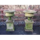 A pair of carved sandstone Urns on pedestal bases 3ft 2in H x 2ft D