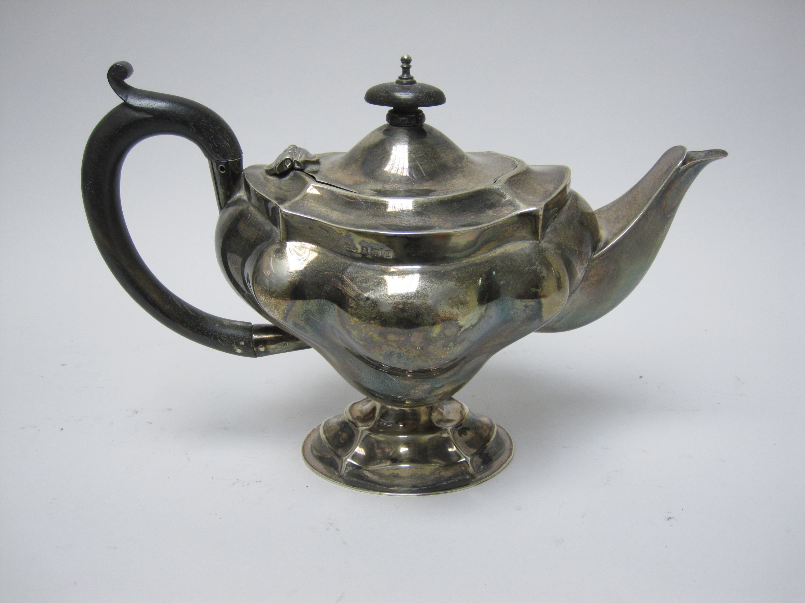 A George V silver Teapot of shaped oval form with ebonised handle, Birmingham 1911