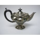 A George V silver Teapot of shaped oval form with ebonised handle, Birmingham 1911