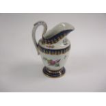 A Tournai helmet-shaped Milk Jug floral painted in coloured enamels, blue and gilt rims, 6 1/2 in H,