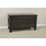 A 17th Century oak Coffer with plank lid above three floral carved arcade panels, 4ft 3in