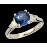 A Sapphire and Diamond three stone Ring claw-set round sapphire, 2.06cts, between two trillion-cut