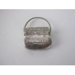 A Victorian silver Vinaigrette in the form of a handbag with scroll engraving and spiral swing