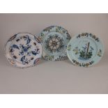Three Delft Plates, one possibly Lambeth with blue and iron red designs, 9in D, a Plate with
