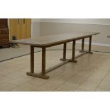 A large Gordon Russell Cotswold oak Refectory Table with thick plank top on three pairs of octagonal