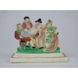 A rare Swansea polychrome porcelain flat back Group, c1818, depicting a piper, youth singing from