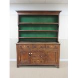 A 19th Century oak Dresser, the rack with an angled cornice over three shelves within shaped