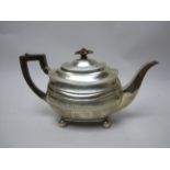 A George III silver boat shape Teapot with leafage engraved frieze on ball feet, London 1811