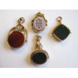 An 18ct gold Swivel Fob, two 9ct gold Swivel Fobs and another stamped 10, all set carnelian and