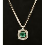 An Emerald and Diamond Pendant claw-set round emerald in halo frame set brilliant-cut diamonds on