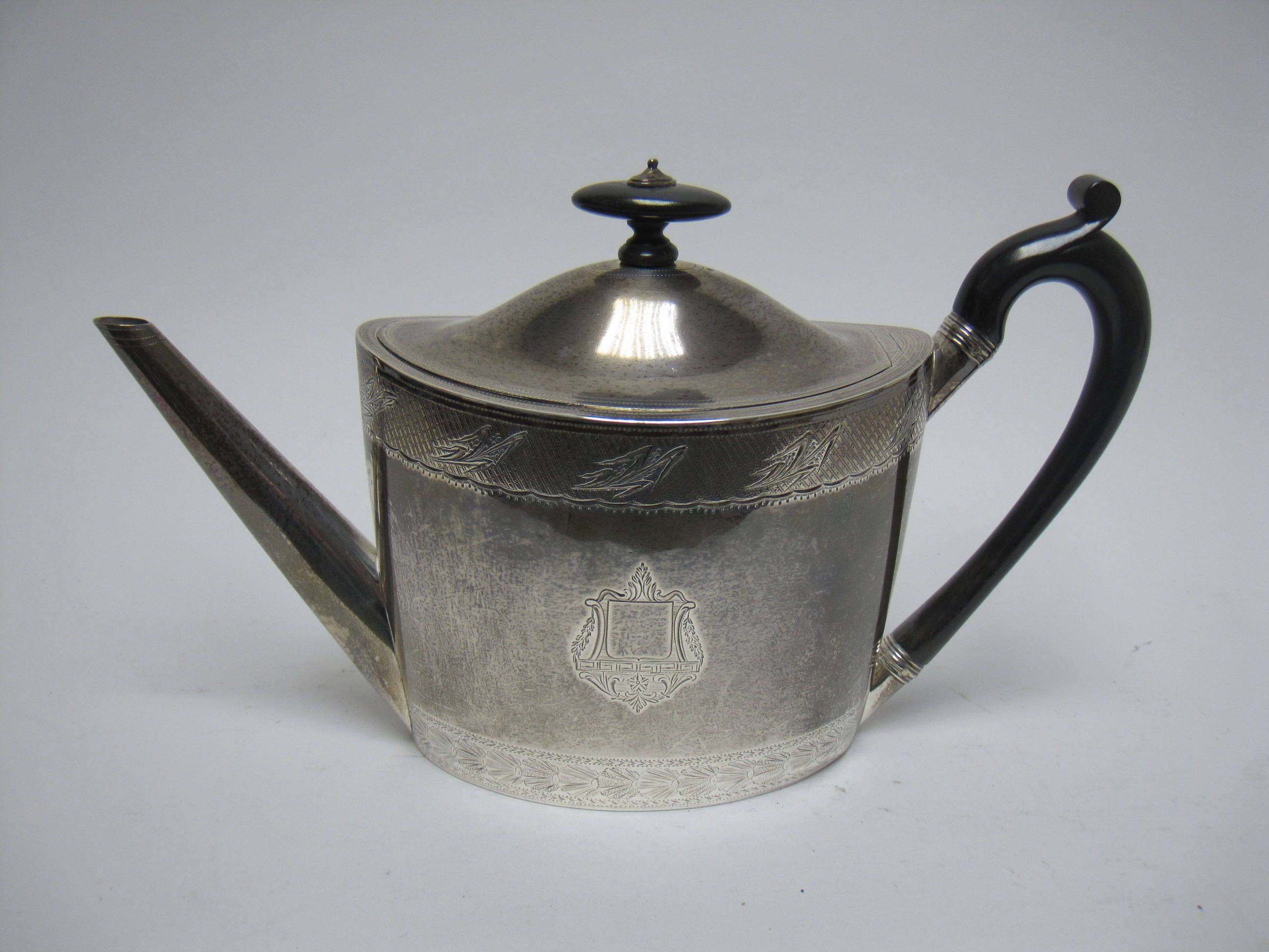 A George III silver oval Teapot with engraved frieze and crests, ebonised handle, London 1797, - Image 4 of 21