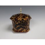 An early 19th Century tortoiseshell octagonal Tea Caddy with a domed lid, ivory finial and turned