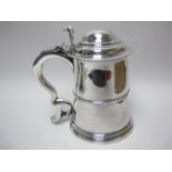 A George II silver Quart Tankard of straight tapering form with remains of engraved coat of arms,