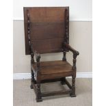 An antique oak Monk's Bench with hinged top/chair back, solid seat on turned and square supports,